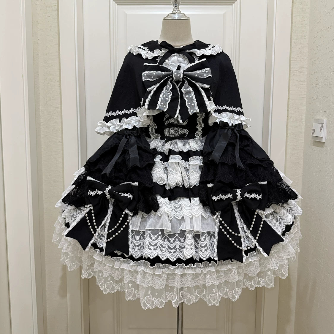 Lady Han Cross Heart Knot Sweet JSK Dress in pastel fabric with bow accents and lace details, showcasing elegant Lolita fashion.