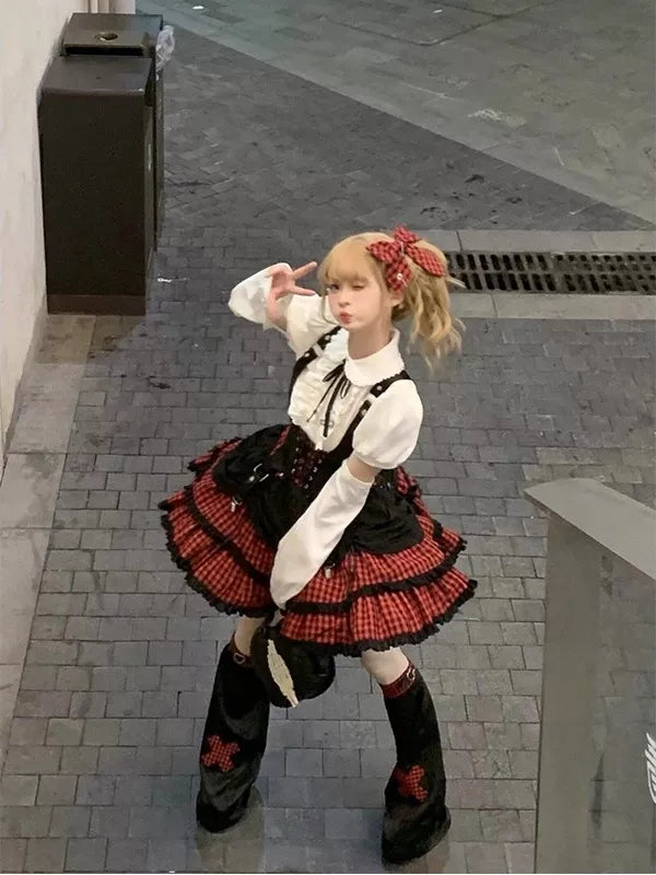 Black-and-red plaid punk Lolita outfit shown on a model outdoors.