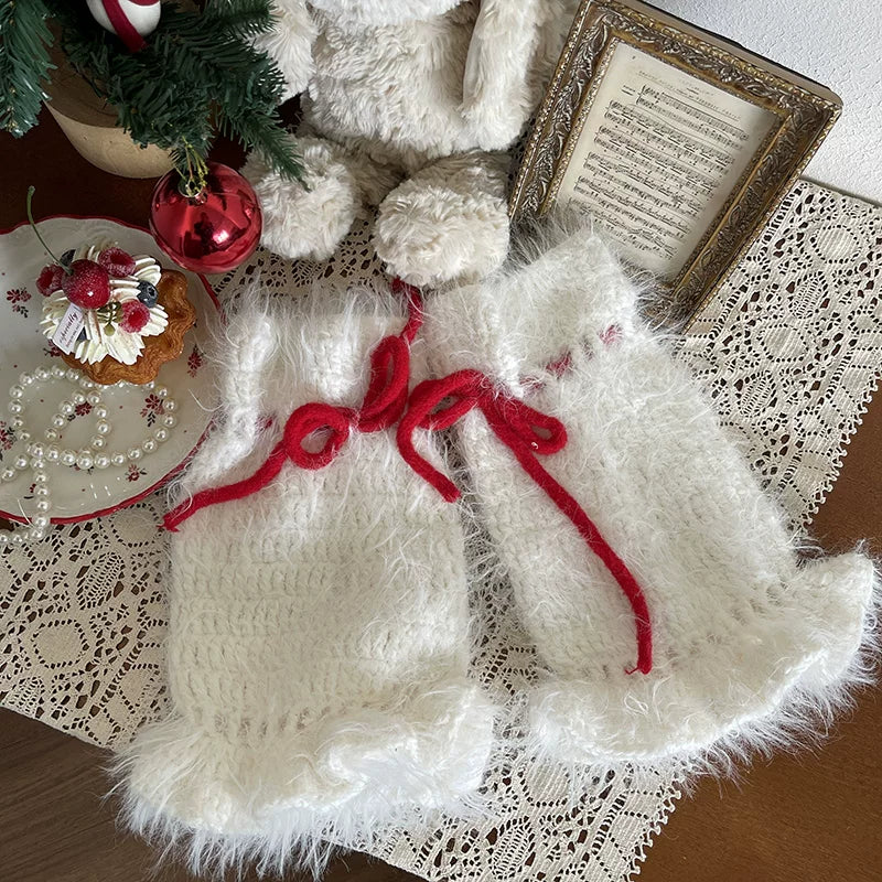 White and red hand-crocheted sock covers with red bows worn over white tights