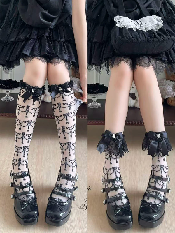 Black-and-white patterned socks with bow and lace accents styled on a model.