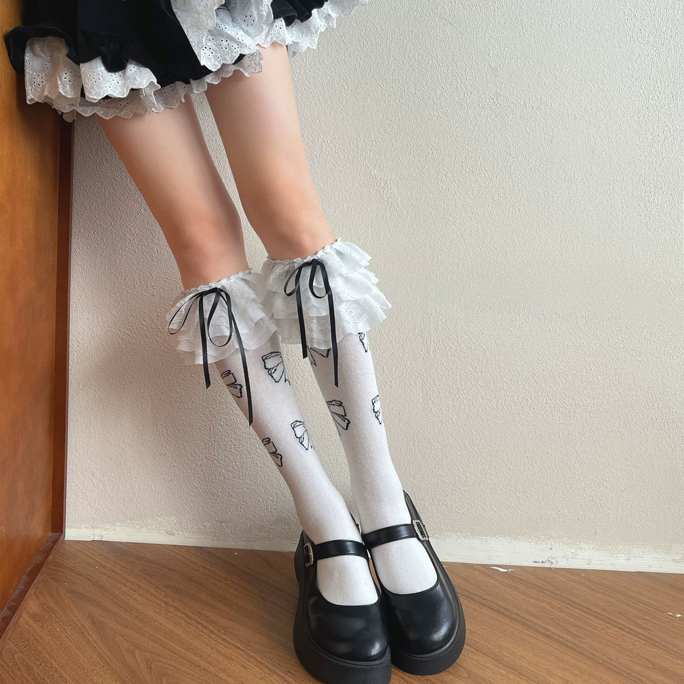 Black Sweet Lolita mid-calf sock with tiered lace ruffle cuff and bow details