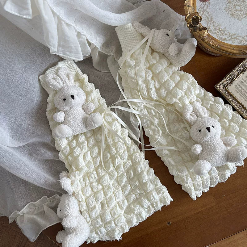 Cream gathered sock cuff with white garter straps, satin bow, and plush teddy bear appliqués