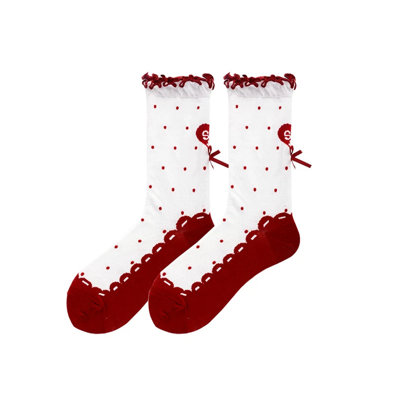 Black and white polka dot socks with ruffled trim and bow accent
