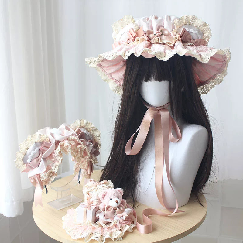 Pink antique-doll bear headwear with ruffles and bows on a mannequin.