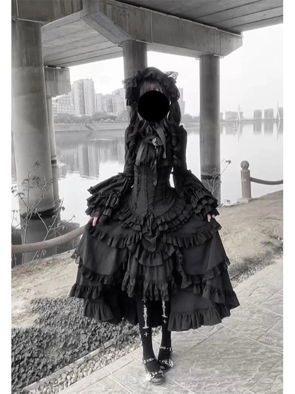 Black ruffled blouse-and-skirt set with princess sleeves and a tiered skirt.