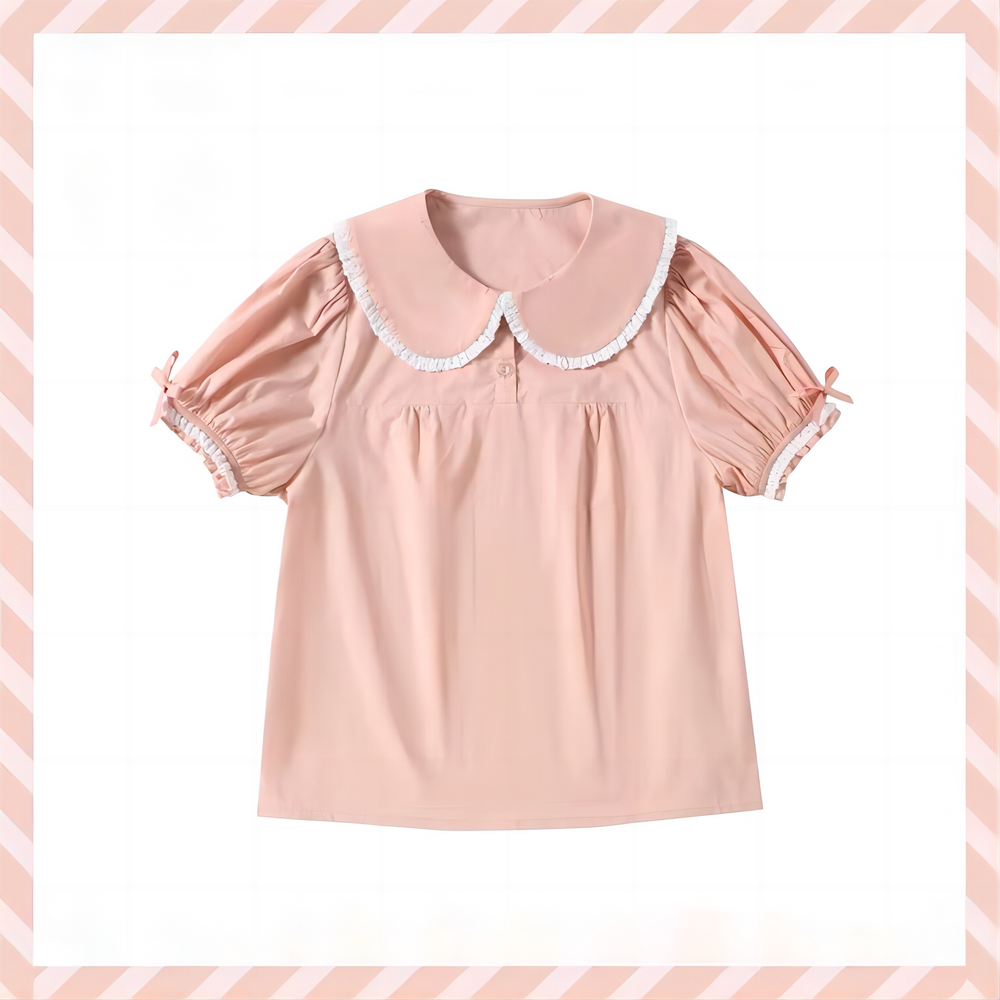 White Sweet Lolita blouse with ruffled Peter Pan collar, puffed short sleeves, and heart embroidery, displayed flat.