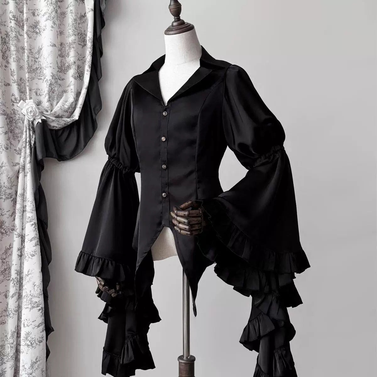 Red V-neck blouse with voluminous tiered ruffle sleeves shown front and back on a mannequin.