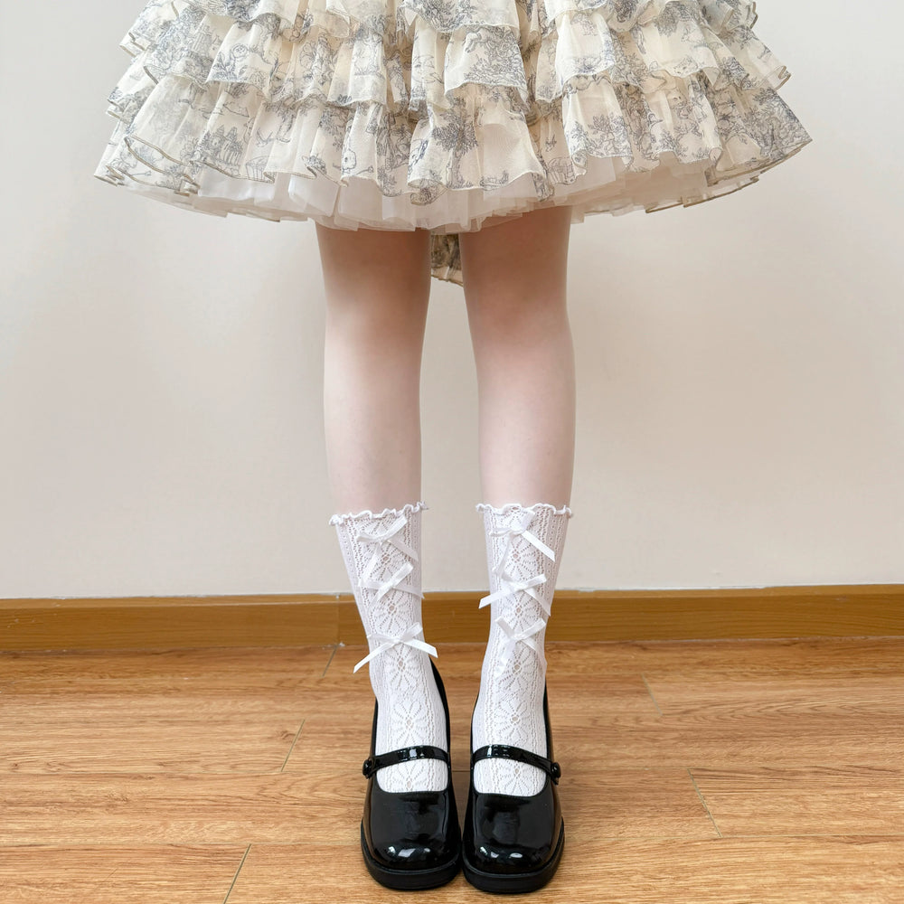 White openwork lace socks with ribbon lacing and decorative trim worn with a Lolita outfit
