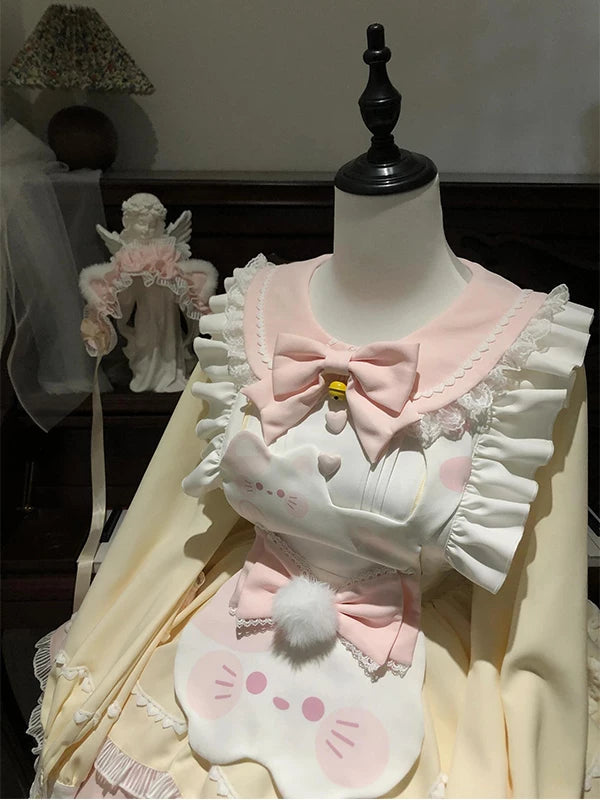Pink-and-cream Lolita JSK dress with a cat-motif suspender apron shown on a mannequin