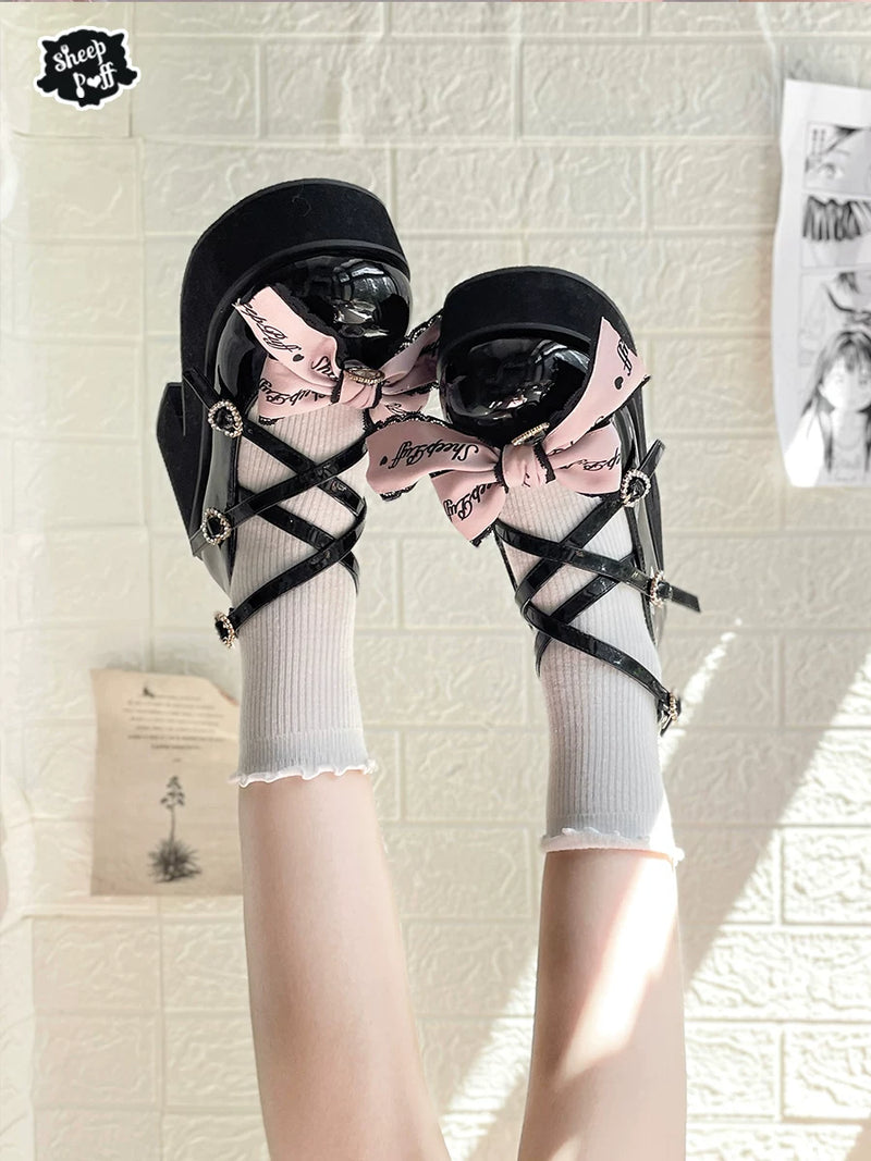 Sheep Puff black and pink lace platform Lolita shoes with puff embellishments and chunky soles.