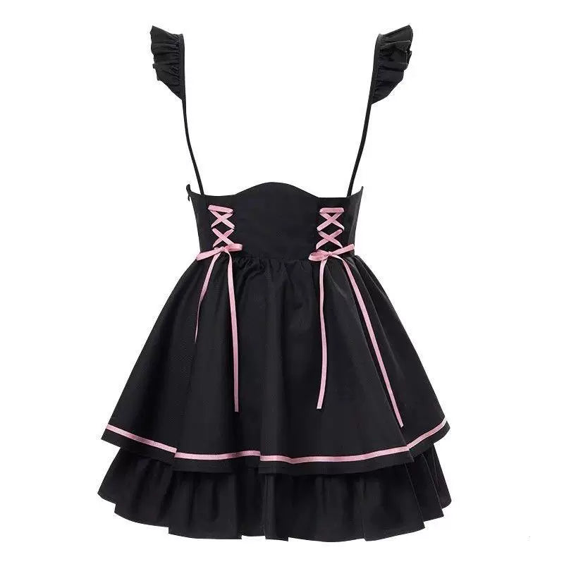 Black pinafore dress with pink lace-up ribbons, pink hem trim and a ruffled lower tier on white.