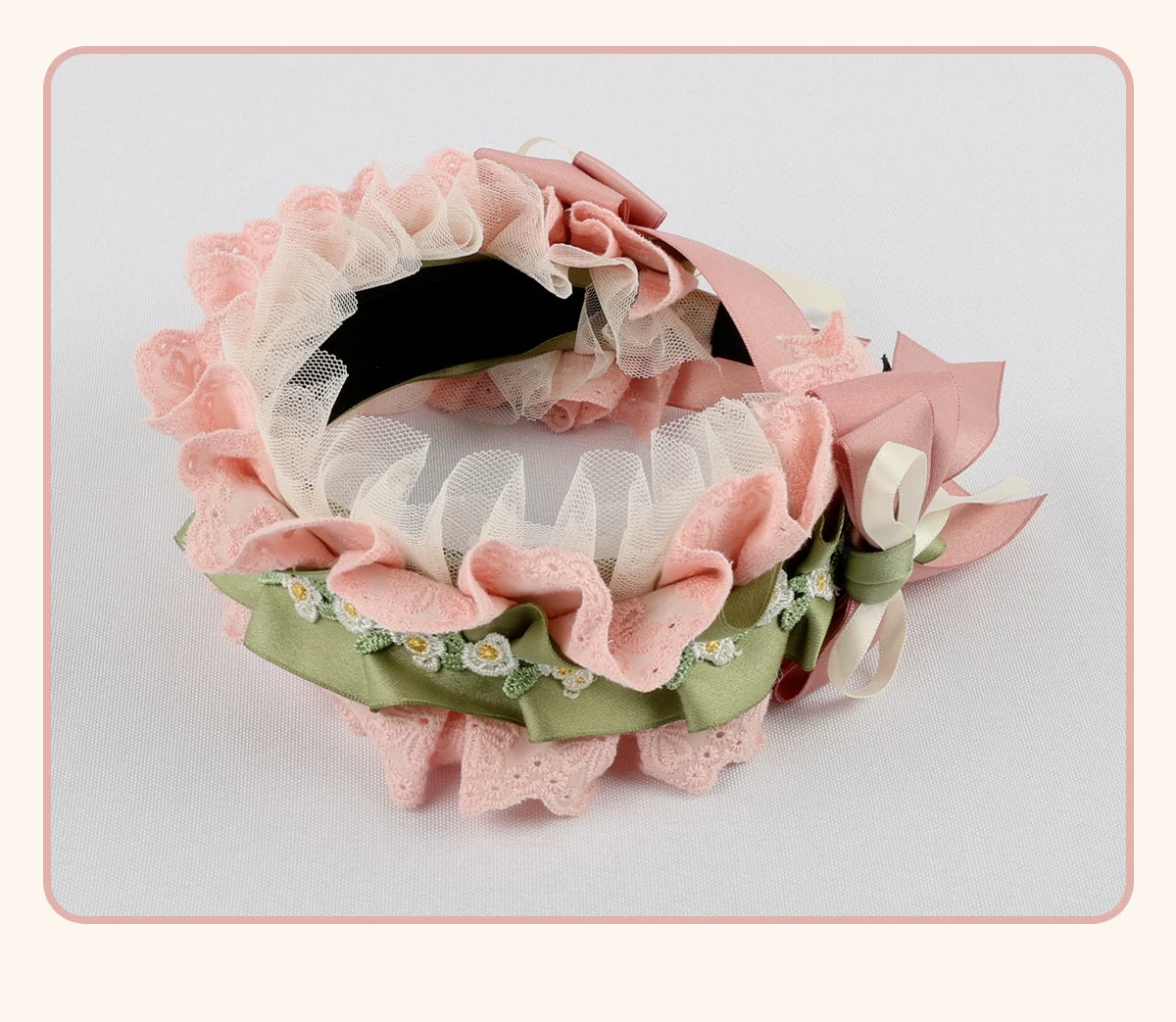 Pink and cream floral Lolita flat hat with ruffles, bows and green leaf accents.