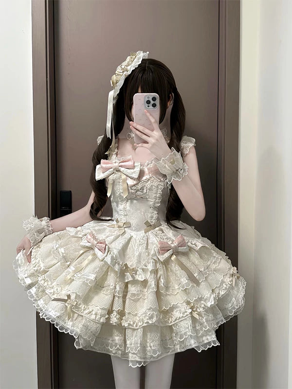 Apricot lace Lolita dress with pink bows and a large train