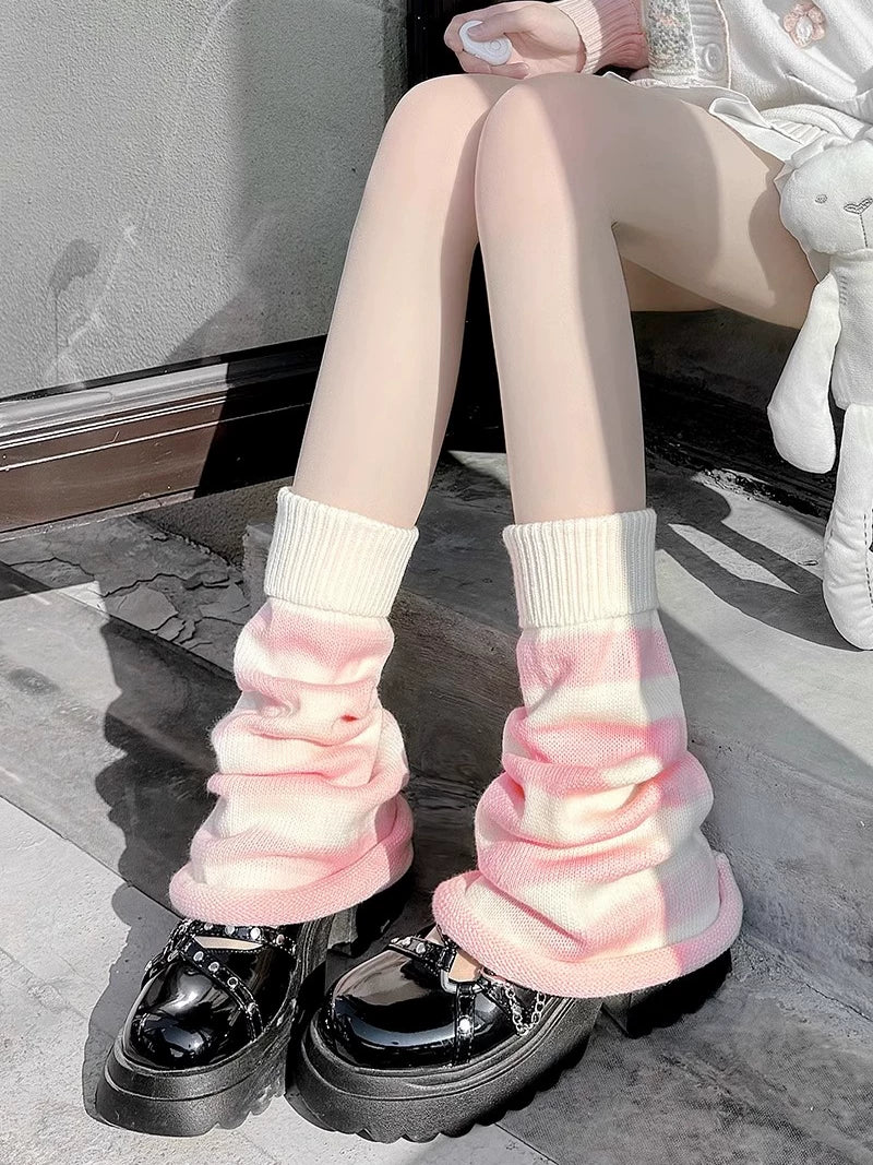 Pink-white striped knit leg warmers gathered above black platform shoes.