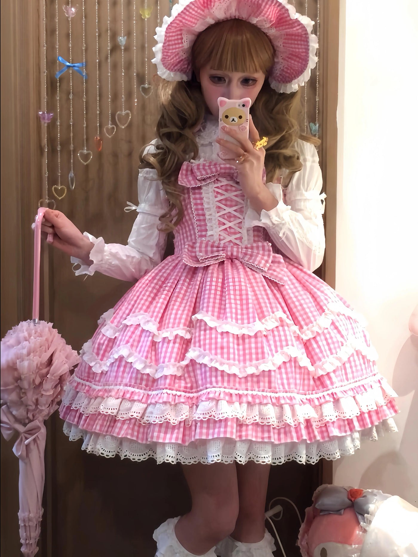 Pink gingham sweet lolita JSK with tiered ruffled skirt and white lace trim, styled with a white blouse and matching bonnet