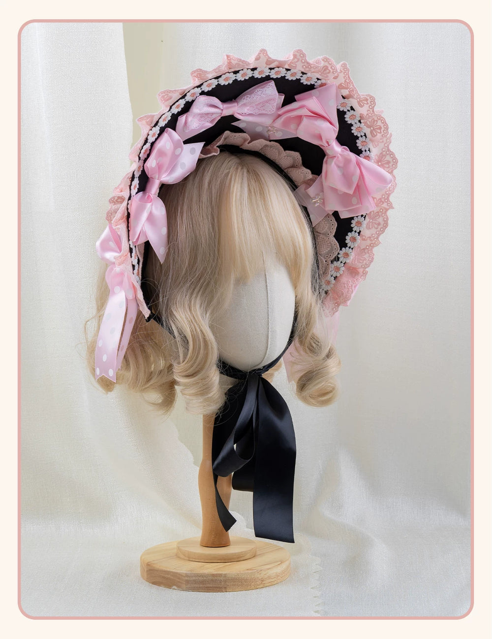 Pink and black Lolita headwear with polka-dot bows and lace trim displayed on mannequins.