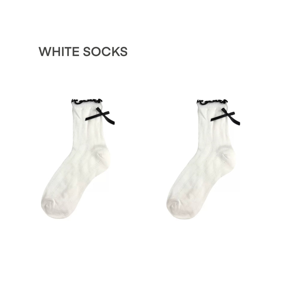 Pair of grey mid-calf socks with black bow details on a white background.