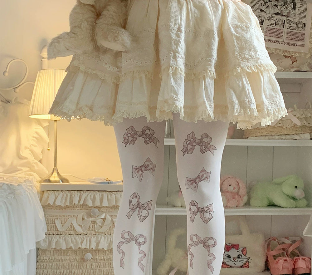 Velvet tights with scattered bow prints in three colourways