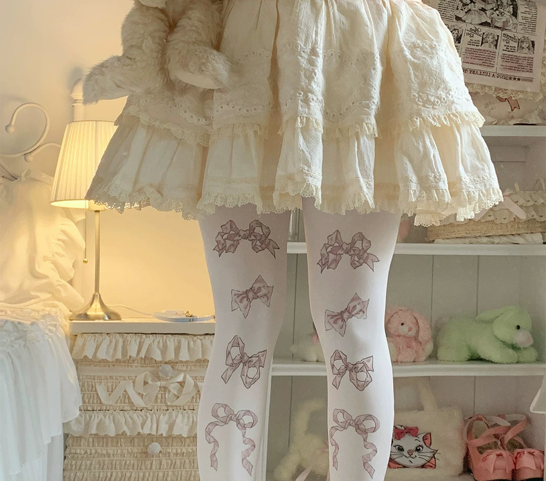 Velvet tights with scattered bow prints in three colourways