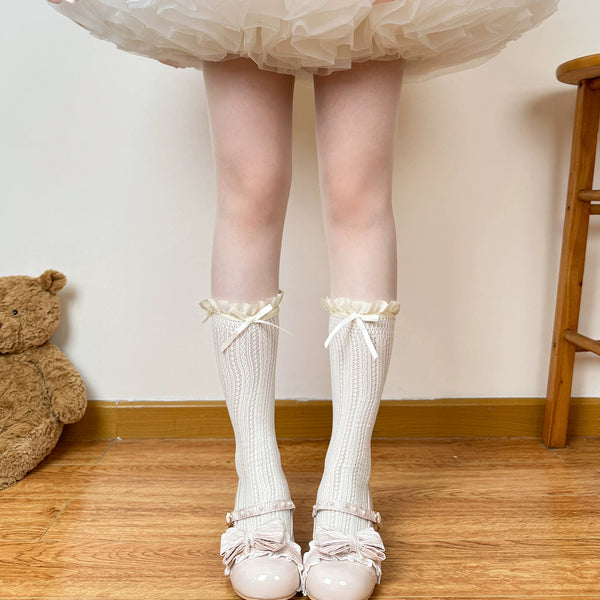 White lace socks with ruffle tops and bows styled with pale pink shoes