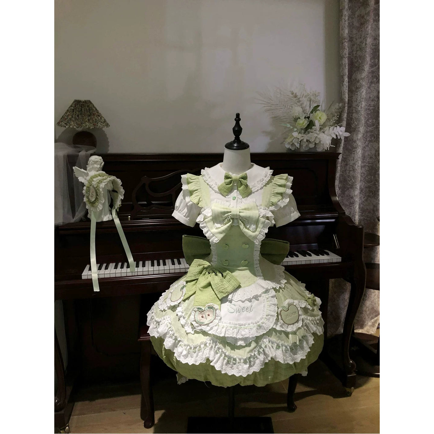 Detail of lace-trimmed Peter Pan collar and sage green bow on the Lolita dress