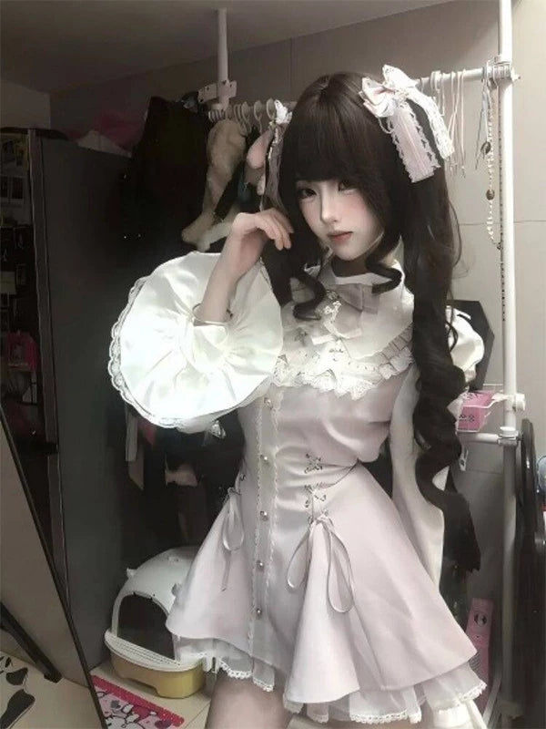 Pink lace-trimmed Lolita dress and shorts set worn by a model, with a bow tie.