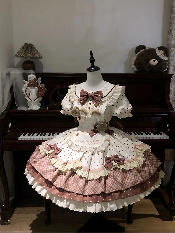 Cream and brown bear-themed OP dress set with apron and bow on a mannequin.