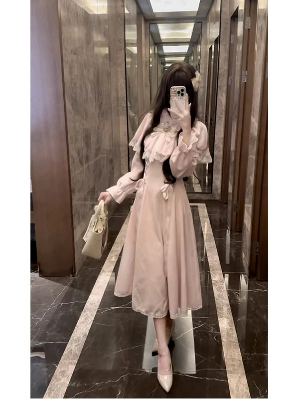 Pink long-sleeve dress with lace cape overlay and bows worn in an elevator.