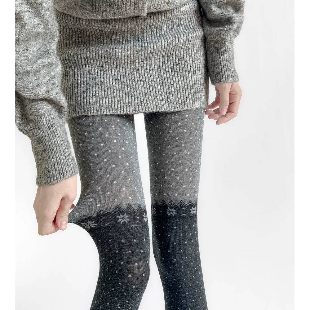 Fantasy Doll gray tights with fine polka dots and a contrasting snowflake panel.