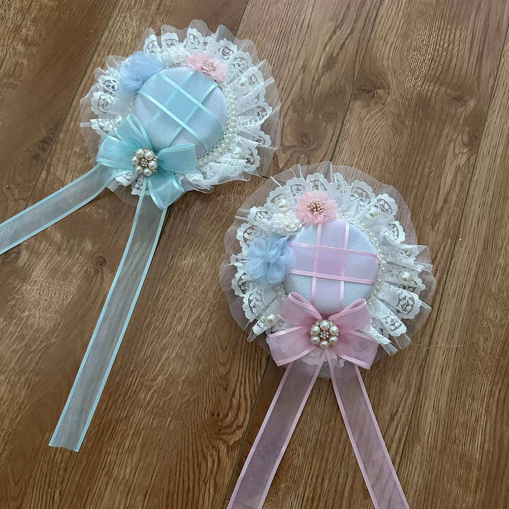 Pastel lace accessories displayed with floral headpieces and a light blue dress coordinate.
