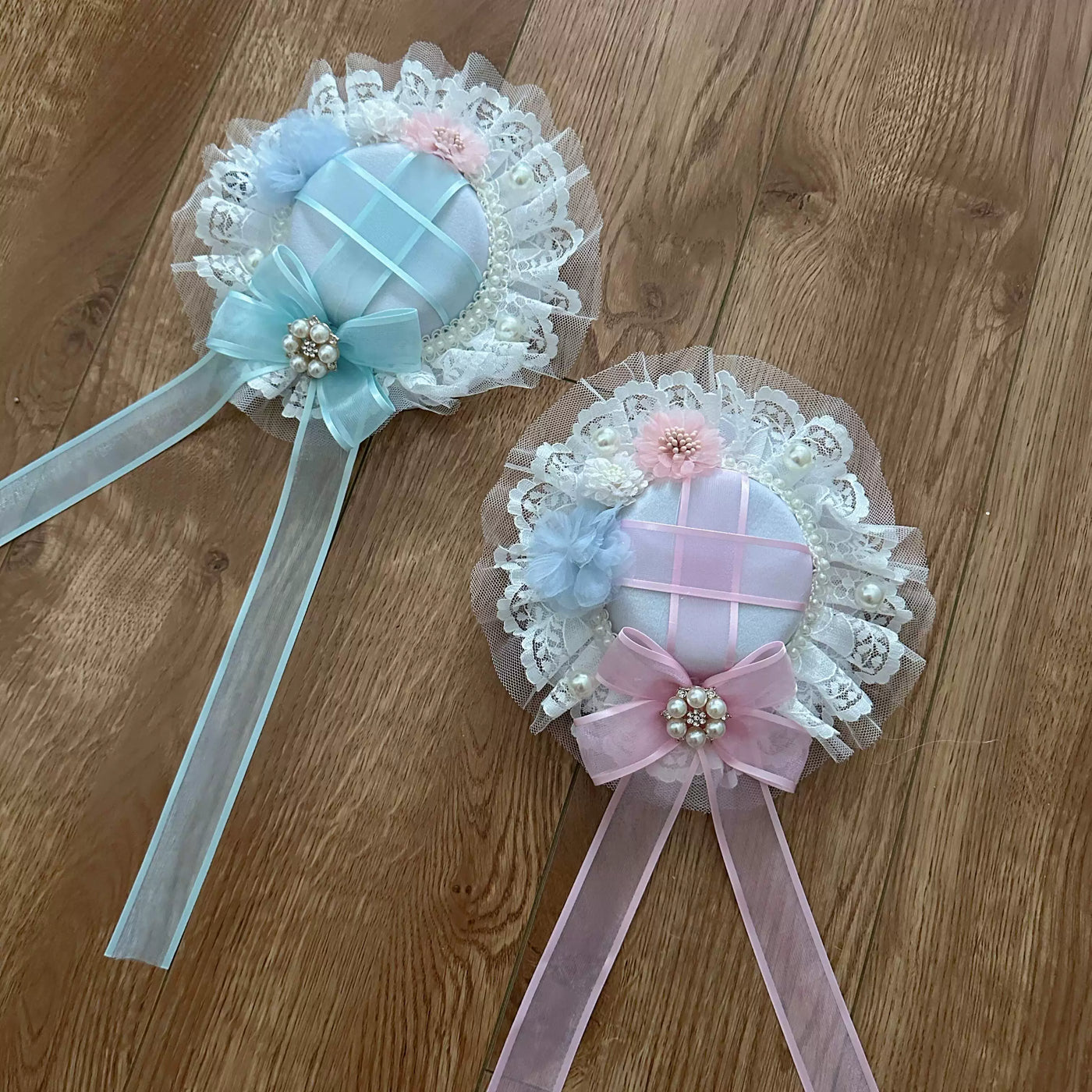 Pastel lace accessories displayed with floral headpieces and a light blue dress coordinate.