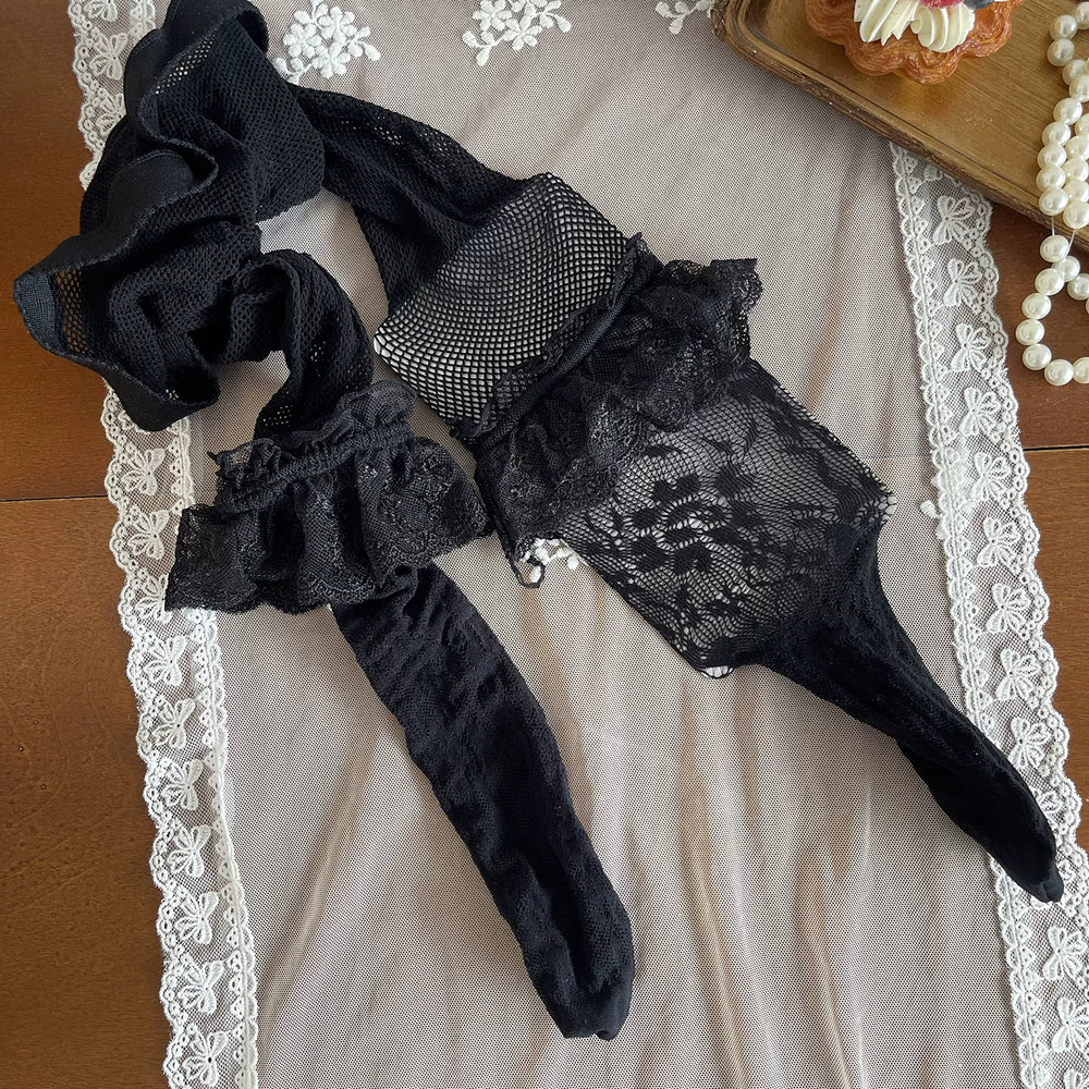 Model wearing black fishnet-and-lace panelled pantyhose with lace thigh bands and glossy platform shoes.