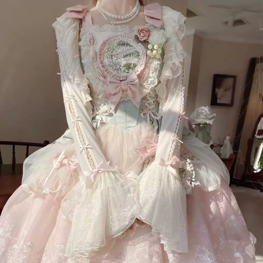 Sweetheart Dream Machine apricot lace cardigan with bows and ruffled edging in a pink-and-ivory coordinate.