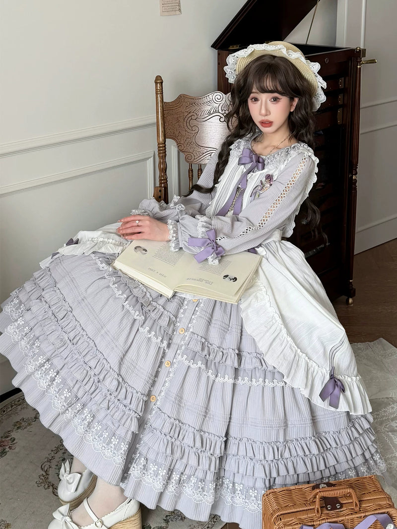 Model wearing the lavender-grey Tasha's Garden Lolita OP dress with tiered skirt and satin bow accents