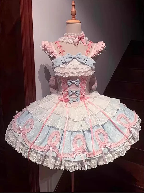 Blue-and-pink JSK dress with layered bows and a large back bow on a mannequin.