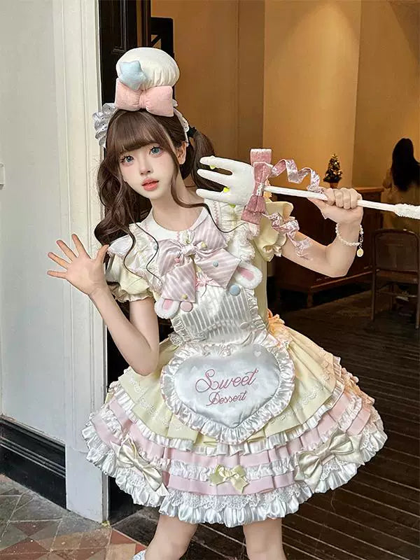 Model wearing a Creamy pastel Sweet Dessert OP dress set with ruffled apron and bow