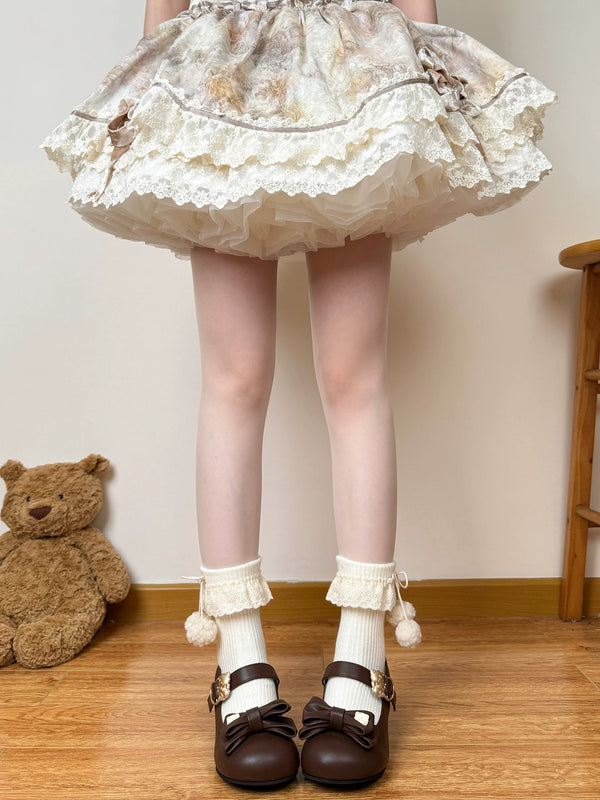 Cream ribbed mid-calf socks with folded lace cuffs, ribbon ties and dangling pom-poms styled with a vintage Lolita skirt and brown Mary Janes.