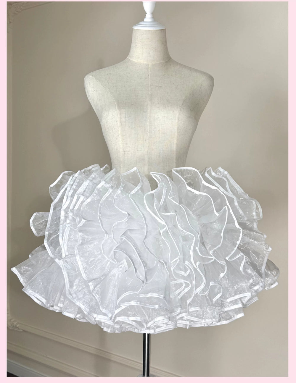 White layered ruffle bell-shaped petticoat displayed on a mannequin.
