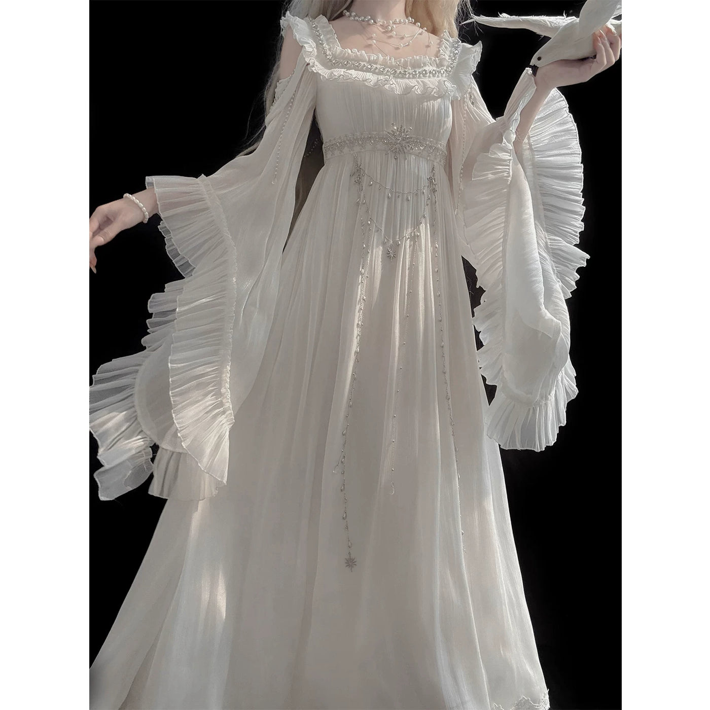 Detail view of off-shoulder neckline and waist chain embellishments on white Lolita dress