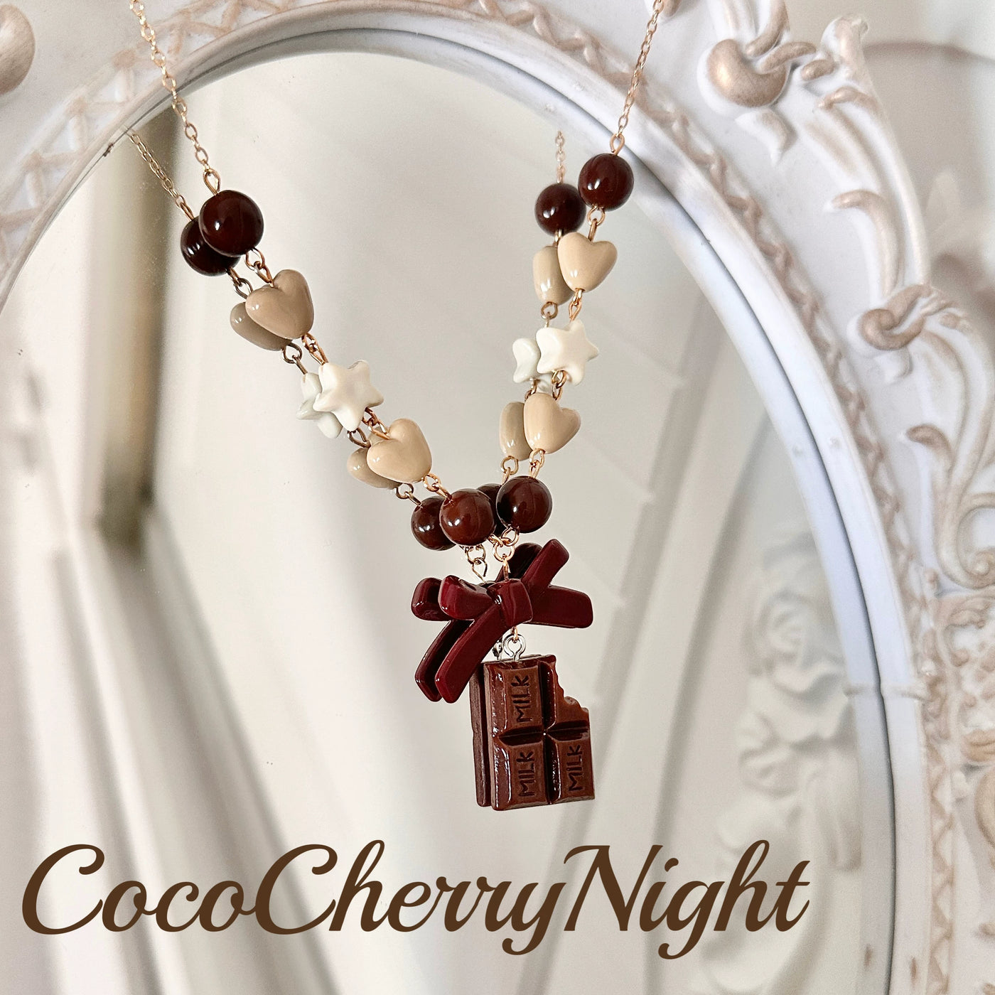 Chocolate-bar pendant necklace with burgundy bow and brown heart-and-star beads.