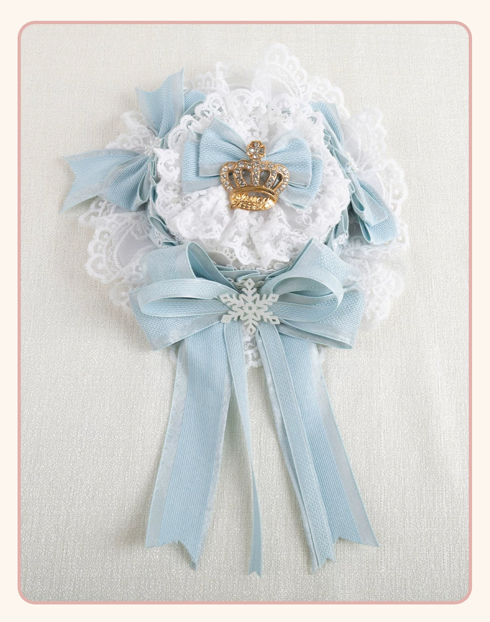 Light-blue bow and white lace headwear with crown and snowflake accents