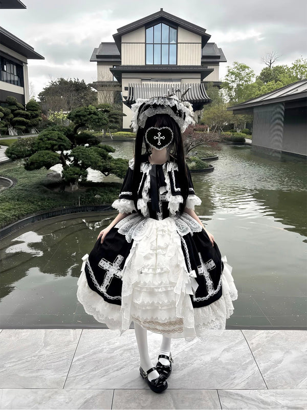 Black-and-white JSK dress with lace cape and hat in a garden setting