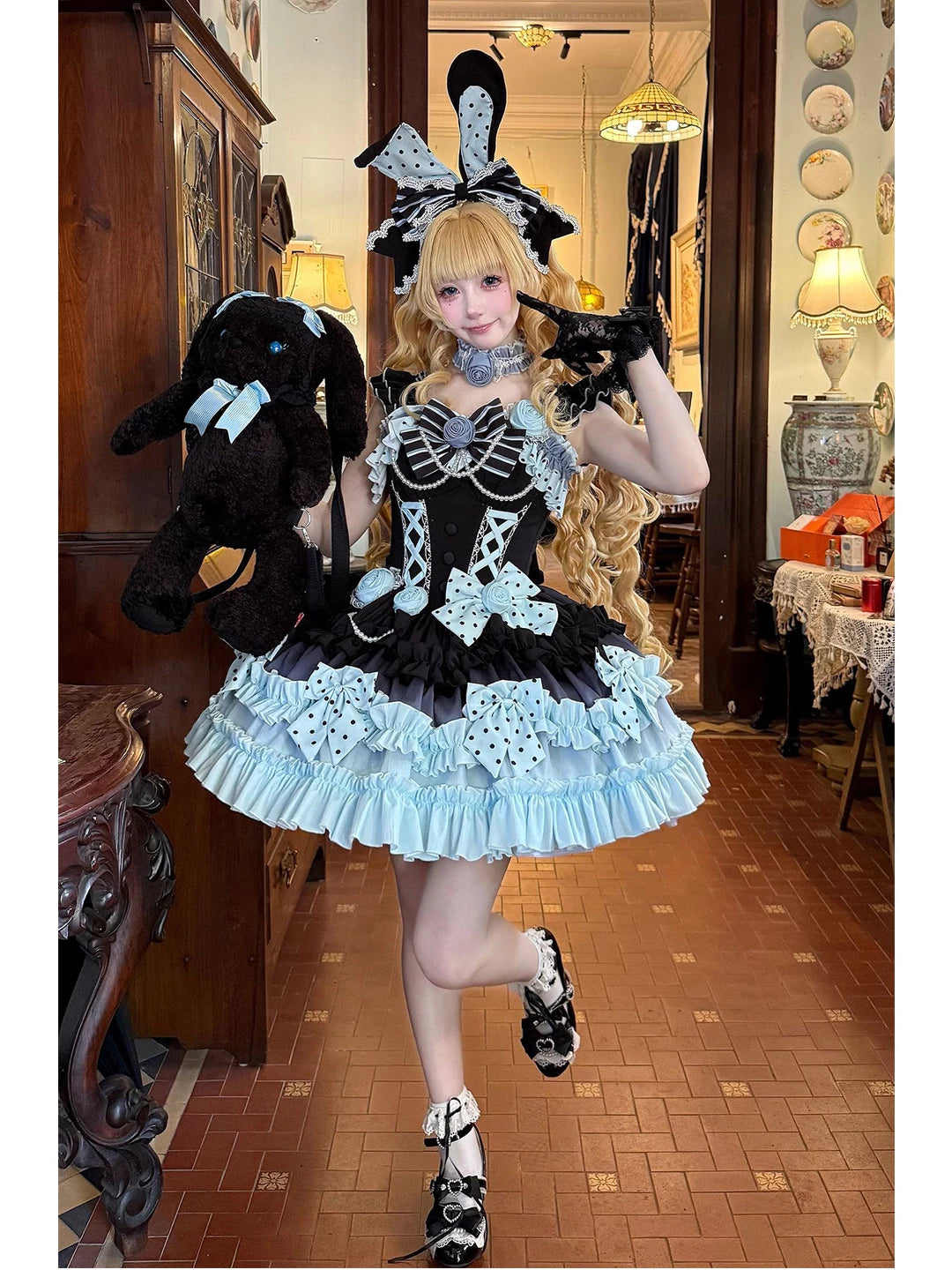 Model wearing a black and pale blue tiered JSK set with bows and a coordinating headpiece.