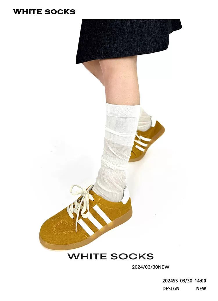 Gathered slouch socks styled with lace-up shoes
