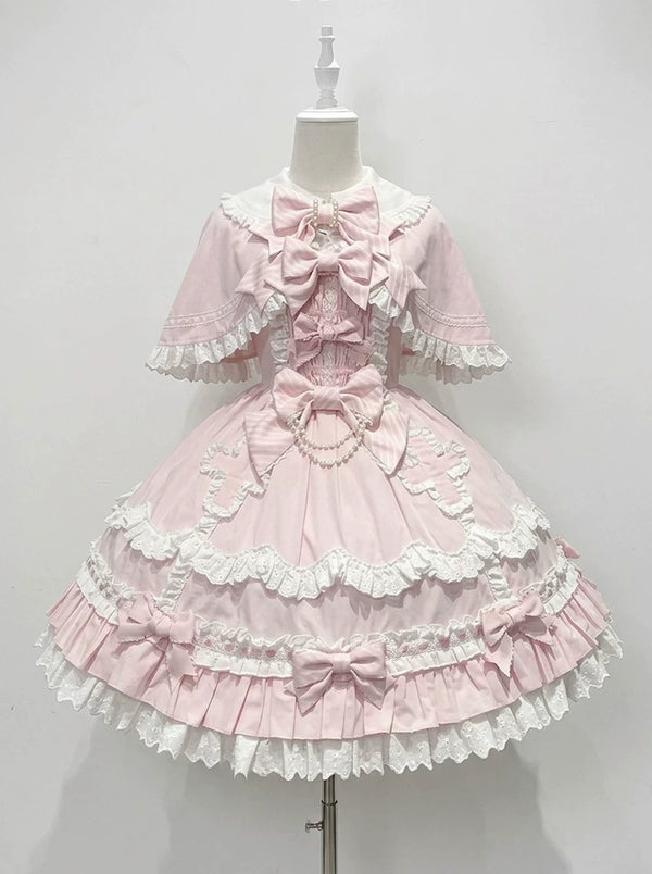 Pale pink bow and lace JSK dress with cape on a mannequin