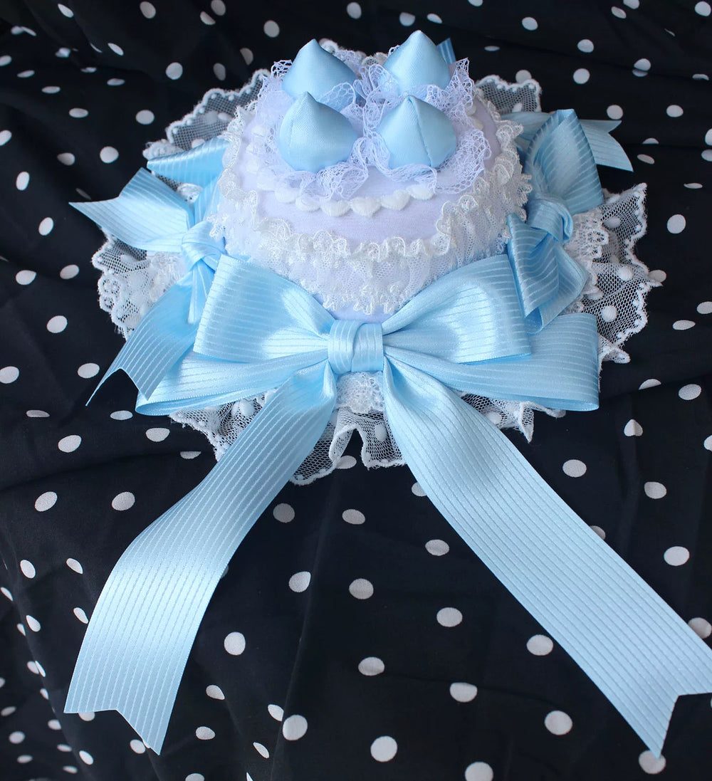 Strawberry angel cake mini top hats with lace and ribbon bows on stands