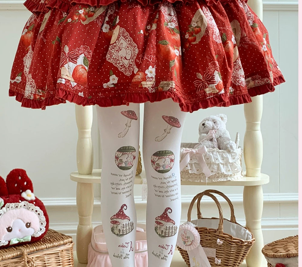 Printed white pantyhose with mushroom motifs styled beneath a red illustrated skirt.