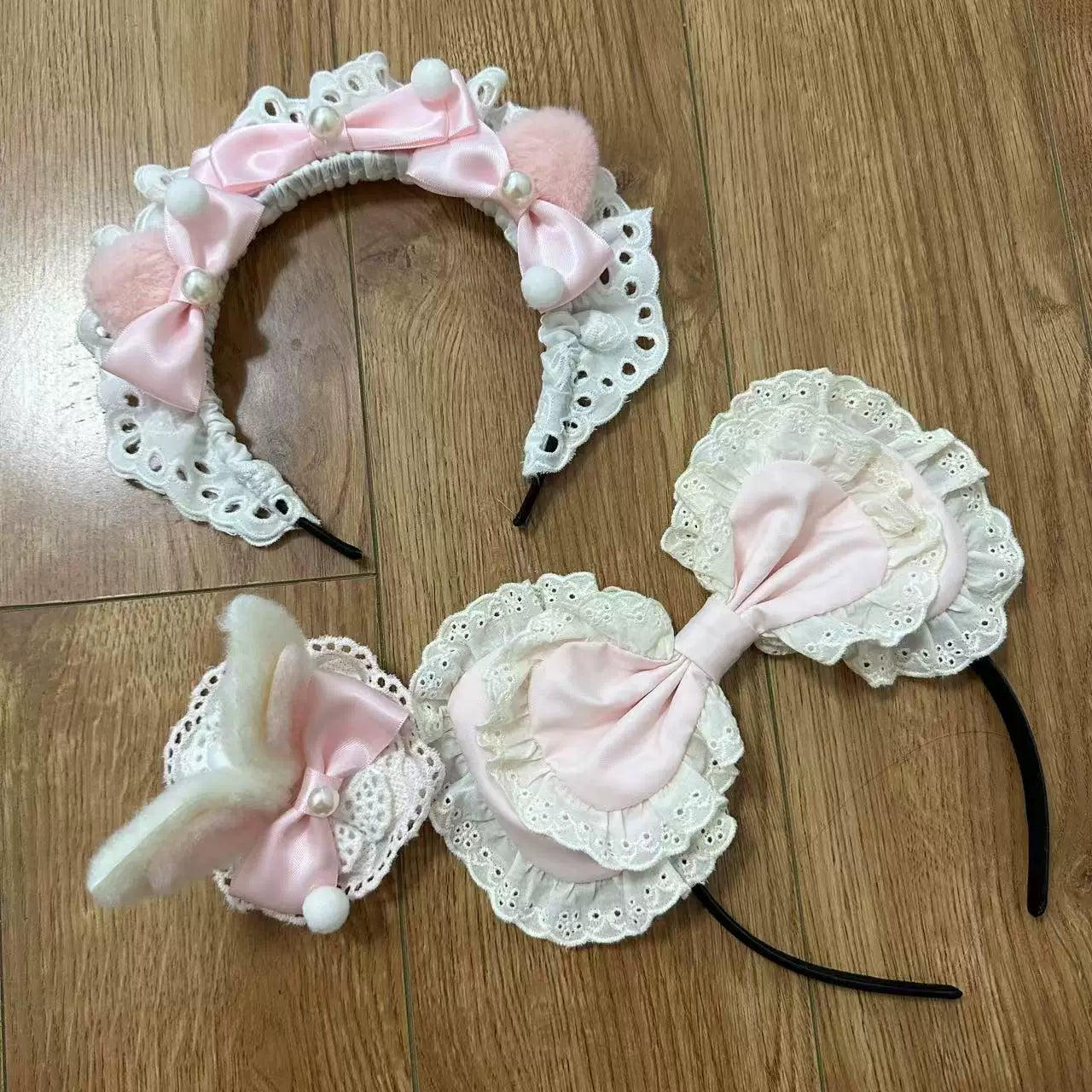 Pink and white short-sleeve dress with lace trim and front buttons in a decorated room.