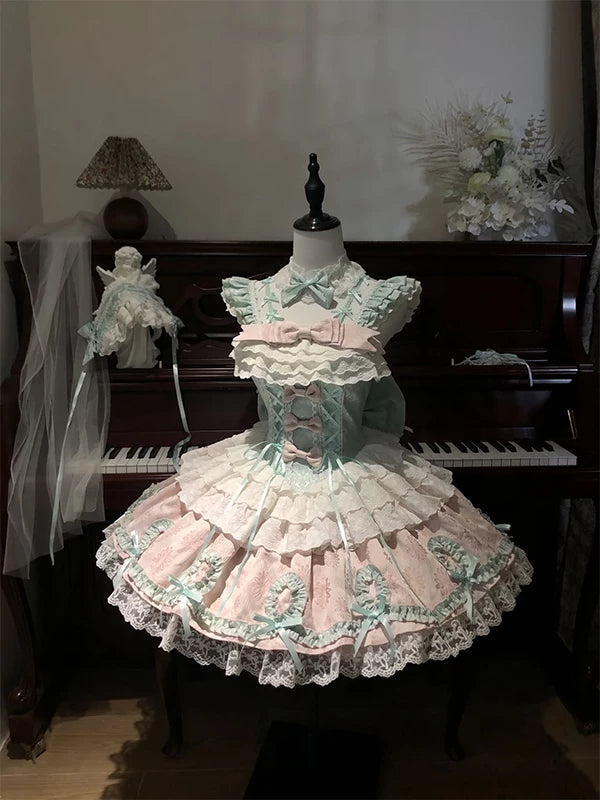 Mint-and-pink JSK dress with accessories displayed on a mannequin.
