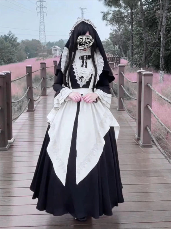 Black-and-white long OP dress with white apron and detachable sleeves on a styled model.